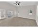 Large living area with neutral carpet, access to outdoors, and big windows at 632 Hitchen Post Dr, Henderson, NV 89011