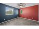 Inviting bedroom with contrasting walls, wood-look floors, ceiling fan, and sun-filled windows at 6713 Guidestar St, North Las Vegas, NV 89084