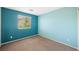 Stylish bedroom with blue accent wall and a large window, providing ample natural light at 6713 Guidestar St, North Las Vegas, NV 89084
