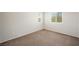 This is a bedroom with two windows and carpeted flooring at 6713 Guidestar St, North Las Vegas, NV 89084