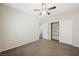 A neutral bedroom with a ceiling fan and closet featuring adjustable shelving at 6713 Guidestar St, North Las Vegas, NV 89084