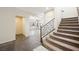 Foyer showcasing staircase with carpet, tile flooring and a view into the living area at 6713 Guidestar St, North Las Vegas, NV 89084