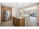 Stylish kitchen featuring a center island, stainless steel refrigerator, and warm wood cabinetry at 6713 Guidestar St, North Las Vegas, NV 89084