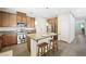 Spacious kitchen with a central island, stainless steel appliances, and barstool seating at 6713 Guidestar St, North Las Vegas, NV 89084