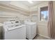 Bright laundry room with washer, dryer and ample shelving at 6713 Guidestar St, North Las Vegas, NV 89084