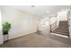 Spacious living room featuring a staircase and tile flooring at 6713 Guidestar St, North Las Vegas, NV 89084