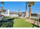 Charming home featuring a manicured lawn and palm trees, creating a welcoming curb appeal at 7026 Westpark Ct, Las Vegas, NV 89147