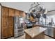Modern kitchen featuring stainless steel appliances and an island with granite countertops at 7026 Westpark Ct, Las Vegas, NV 89147