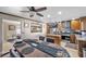 Spacious kitchen with stainless steel appliances and an island, open to a dining area with an aquarium window at 7026 Westpark Ct, Las Vegas, NV 89147