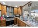 Modern kitchen featuring stainless steel appliances, granite counters, and backyard views at 7026 Westpark Ct, Las Vegas, NV 89147