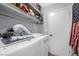 Functional laundry room with washer, dryer, shelving, and a clean, organized space at 7026 Westpark Ct, Las Vegas, NV 89147