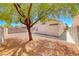 The backyard with a mature tree, and gravel at 7212 Nordic Lights Dr, Las Vegas, NV 89119