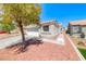 Charming single-story home featuring a two-car garage, low-maintenance landscaping, and a inviting walkway at 7212 Nordic Lights Dr, Las Vegas, NV 89119