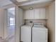 Bright laundry room with washer and dryer, featuring direct access to the backyard at 7212 Nordic Lights Dr, Las Vegas, NV 89119