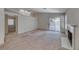 Open living room features a fireplace, high ceilings with skylights, and a sliding glass door to the yard at 7212 Nordic Lights Dr, Las Vegas, NV 89119