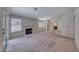 Spacious living room featuring neutral carpet, fireplace, and windows with blinds for natural light at 7212 Nordic Lights Dr, Las Vegas, NV 89119