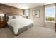 Serene main bedroom featuring a wood accent wall, large bed, side tables, and serene artwork at 7388 Daly Grove St, Las Vegas, NV 89113