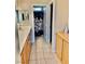 A bathroom with wood cabinets, tile floor, and a shower with a floral shower curtain at 7513 Brisa Del Mar Ave, Las Vegas, NV 89179