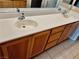 A bathroom vanity featuring double sinks, wood cabinets, and a spacious countertop at 7513 Brisa Del Mar Ave, Las Vegas, NV 89179