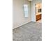A carpeted bedroom featuring neutral walls and an open doorway to the bathroom at 7513 Brisa Del Mar Ave, Las Vegas, NV 89179