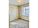 Neutral bedroom with a window and soft carpeting, bathed in natural light at 7513 Brisa Del Mar Ave, Las Vegas, NV 89179