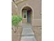 Close-up of front porch, showing arched entryway and stone landscape at 7513 Brisa Del Mar Ave, Las Vegas, NV 89179