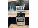 Close-up of kitchen appliances, featuring stainless steel oven and microwave at 7513 Brisa Del Mar Ave, Las Vegas, NV 89179