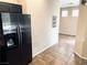 Kitchen area with stainless steel refrigerator and tile flooring at 7513 Brisa Del Mar Ave, Las Vegas, NV 89179