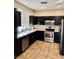 Well-equipped kitchen with stainless steel appliances and dark wood cabinets at 7513 Brisa Del Mar Ave, Las Vegas, NV 89179