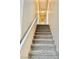 A carpeted staircase with white railing leading to the upper level of the home at 7513 Brisa Del Mar Ave, Las Vegas, NV 89179