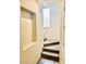 A carpeted staircase with white railing and a window that allows for natural light at 7513 Brisa Del Mar Ave, Las Vegas, NV 89179