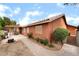 View of the back of the house with a covered patio, grill, fire pit, and pathway at 7517 Elk Meadows Ct, Las Vegas, NV 89131