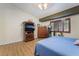 Cozy bedroom with a wooden dresser, wood-style flooring, and warm, inviting natural light at 7517 Elk Meadows Ct, Las Vegas, NV 89131