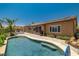 Inviting backyard oasis featuring a sparkling pool, lush landscaping, and patio with a pergola at 7914 Elk Mountain St, Las Vegas, NV 89113