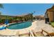 Serene backyard featuring a freeform pool, lounging chairs, and a charming outdoor pergola at 7914 Elk Mountain St, Las Vegas, NV 89113