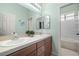 Bright bathroom with double sinks, tiled countertop, and a separate shower/tub area at 7914 Elk Mountain St, Las Vegas, NV 89113