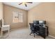 Functional office space featuring a sleek black desk, tiled floors, and bright natural light at 7914 Elk Mountain St, Las Vegas, NV 89113