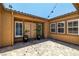 Private courtyard with string lights, neutral stucco walls, an artisan brick floor, and double front doors at 7914 Elk Mountain St, Las Vegas, NV 89113