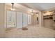 Spacious entryway featuring neutral paint, plantation shutters, tile floors, and views into the living area at 7914 Elk Mountain St, Las Vegas, NV 89113