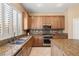 This modern kitchen boasts stainless appliances, granite countertops, a stylish tile backsplash, and bright, natural light at 7914 Elk Mountain St, Las Vegas, NV 89113