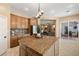 Spacious kitchen features granite counters, island, stainless appliances, and easy access to an adjacent living room at 7914 Elk Mountain St, Las Vegas, NV 89113