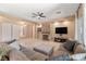 Comfortable living room featuring a stone fireplace, ceiling fan, neutral paint, and tile floors at 7914 Elk Mountain St, Las Vegas, NV 89113