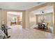 Open-concept living space featuring tile floors, neutral walls, and views into the dining and kitchen area at 7914 Elk Mountain St, Las Vegas, NV 89113