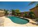 Private pool surrounded by lush landscaping and brick patio, perfect for outdoor relaxation at 7914 Elk Mountain St, Las Vegas, NV 89113