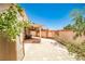 Paved backyard featuring a covered patio with seating and a neutral-colored privacy wall at 7929 Palace Monaco Ave, Las Vegas, NV 89117