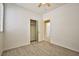 Bright bedroom features a ceiling fan, wood-look flooring, closet, and white walls at 7929 Palace Monaco Ave, Las Vegas, NV 89117