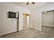 Bedroom featuring wood flooring, ceiling fan, and access to bathroom at 7929 Palace Monaco Ave, Las Vegas, NV 89117