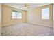 Spacious bedroom with two windows, tile flooring, and neutral colored walls at 7929 Palace Monaco Ave, Las Vegas, NV 89117