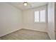 Well-lit bedroom with wood-look flooring, ceiling fan, and window with white shutters at 7929 Palace Monaco Ave, Las Vegas, NV 89117