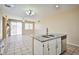 Kitchen island with granite countertops and stainless steel dishwasher adjacent to living space at 7929 Palace Monaco Ave, Las Vegas, NV 89117